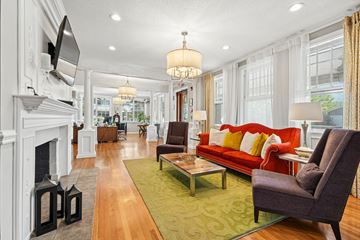 Asheville apartment for rent - A living room with a red couch and a fireplace.