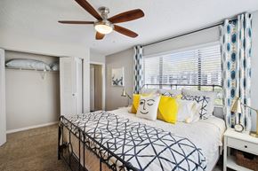 Winter Park apartment for rent - a bedroom with a large bed and a ceiling fan