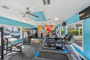 Palm Bay apartment for rent - A gym with a treadmill, exercise bike, and other equipment.