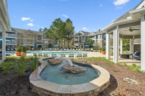 Durham apartment for rent - A small fountain in the middle of a circular pool surrounded by a stone border.