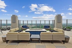 Frisco apartment for rent - A patio with a pool and a view of the city.