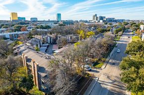 Dallas apartment for rent - A cityscape with buildings and trees in the foreground.