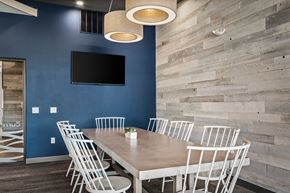 Monona apartment for rent - a dining room with a table and chairs and a tv on the wall