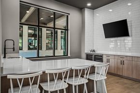 Monona apartment for rent - a kitchen with a white counter top and white chairs