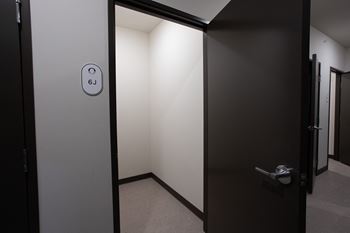 An open bathroom door with a logo on it 