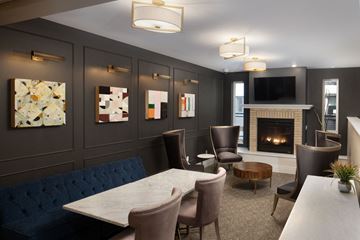 Fargo apartment for rent - a living room with a fireplace and a table and chairs