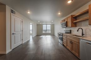 Fargo townhouse for rent - A spacious kitchen with wooden cabinets and a modern design. at Unite Apartments, Fargo, North Dakota