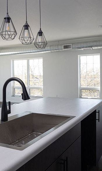 A kitchen with a sink and a window 