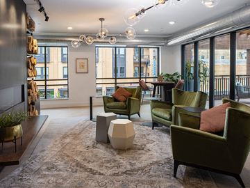 Fargo apartment for rent - a living room with green chairs and a rug