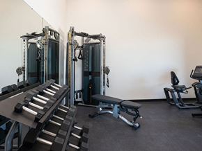 Fargo townhouse for rent - a room filled with cardio equipment and weights at The Landing at 1001 NP, Fargo, North Dakota 58102