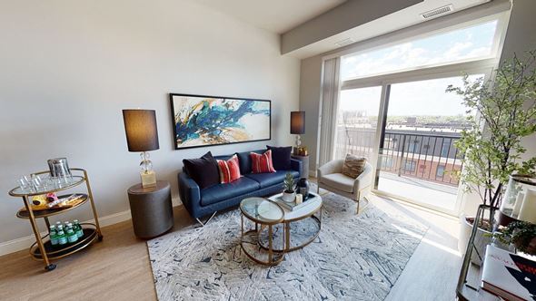 Minneapolis apartment for rent - a living room with a large window and a blue couch