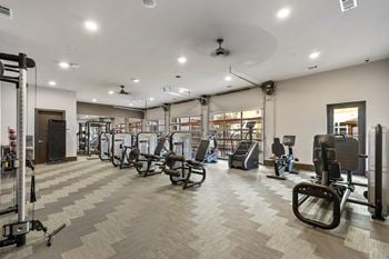 State-of-the-art fitness studios with rolling overhead doors opening to the pool