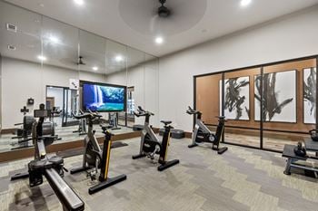 State-of-the-art fitness studios with rolling overhead doors opening to the pool