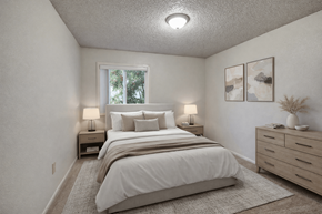 Anchorage apartment for rent - A cozy bedroom at Arctic Sun Apartments with a queen bed dressed in soft white bedding and neutral pillows. Two bedside tables with lamps sit on each side. A wide dresser with décor and wall art adds style, and a window lets in natural light, brightening the calm, neutral space.