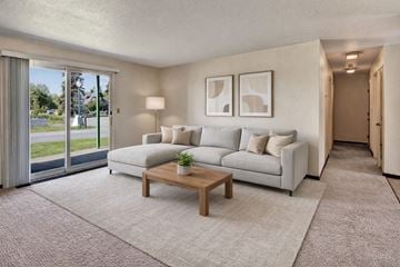 Kenai apartment for rent - A living room with a white couch and a coffee table.