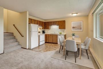 Anchorage apartment for rent - A kitchen with a table and chairs in the middle of the room.