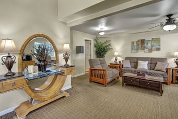 Anchorage apartment for rent - A living room with a couch, chair, and a table with a lamp on it.