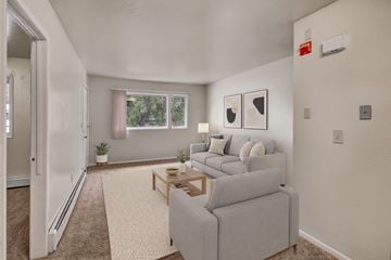 Anchorage apartment for rent - A living room with a grey couch and a small table.