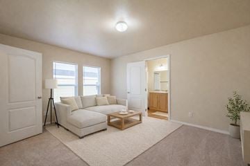 Anchorage apartment for rent - A living room with a white couch and a small wooden table.