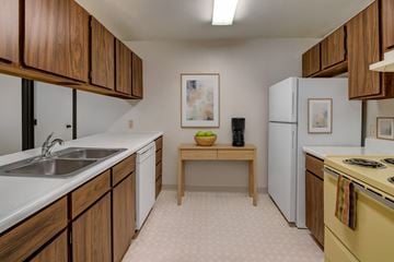 Anchorage apartment for rent - A kitchen with wooden cabinets and a yellow stove.