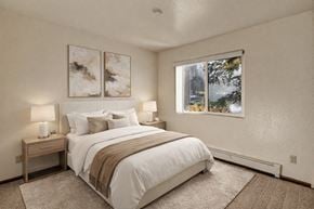 Anchorage apartment for rent - A bedroom with a large bed and two lamps.