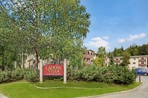 Anchorage apartment for rent - A sign that says Ladera Villa in front of some houses.