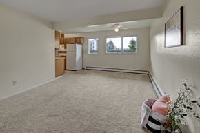 Anchorage apartment for rent - A room with a carpeted floor and a ceiling fan.