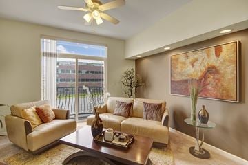 Anchorage apartment for rent - A living room with a couch, a coffee table, and a painting on the wall.