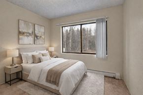 Anchorage apartment for rent - A bedroom with a large bed and two lamps.