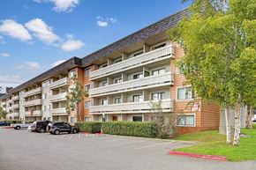 Anchorage apartment for rent - A large apartment building with a parking lot in front.
