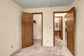 Anchorage apartment for rent - A room with a carpeted floor and two open wooden doors.