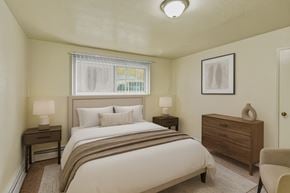 Anchorage apartment for rent - A bedroom with a bed, nightstand, and chair.