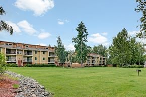 Anchorage apartment for rent - Apartment complex with a green lawn in front.