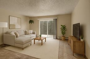 Anchorage apartment for rent - A living room with a white couch, a wooden coffee table, a flat screen TV, and a large window with a view of trees outside.