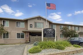 Anchorage apartment for rent - The Rancho Tudor Apartments building has a flag on top.