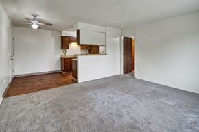 Anchorage apartment for rent - A room with a carpeted floor and a ceiling fan.