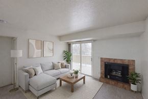 Anchorage apartment for rent - A cozy living room here at Russian Jack with a light gray sectional sofa, a wooden coffee table, and neutral wall art for a clean, modern feel.