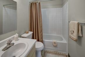 Anchorage apartment for rent - A bathroom with a white tub, toilet, and sink.