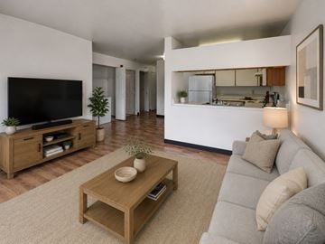 Anchorage apartment for rent - A modern living room with a grey sofa and a wooden coffee table.