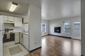 Anchorage apartment for rent - A kitchen with white cabinets and a black oven.
