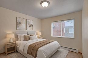 Anchorage apartment for rent - A bedroom with a large bed and two lamps.