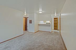 Anchorage apartment for rent - A spacious room with carpeted floor and white walls.