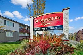Anchorage apartment for rent - A sign for Strawberry Lane Apartment Homes is in front of a building.