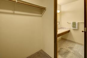 Anchorage apartment for rent - A small bedroom with a bed and a hanging clothesline.