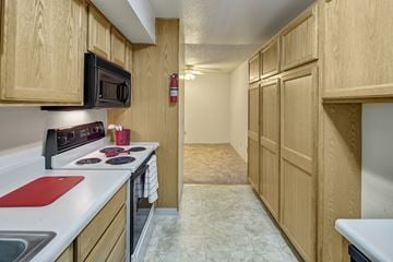 Anchorage apartment for rent - A kitchen with wooden cabinets and a red cutting board.