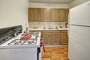 Anchorage apartment for rent - A kitchen with a white stove and wooden cabinets.