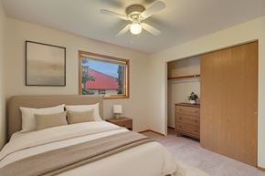 Anchorage apartment for rent - A bedroom with a bed, nightstand, and a window.