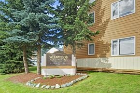 Anchorage apartment for rent - A sign for Wildwood Apartments is in front of a building.