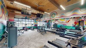Rogers apartment for rent - A gym with a variety of equipment including treadmills and weights.