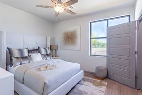 Rogers apartment for rent - A bedroom with a large bed and a ceiling fan.